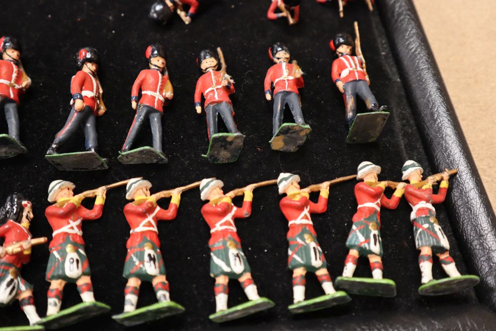 A collection of painted Britains and Holocast lead soldiers, artillery pieces, including some rare dated including Scots Guards chargin